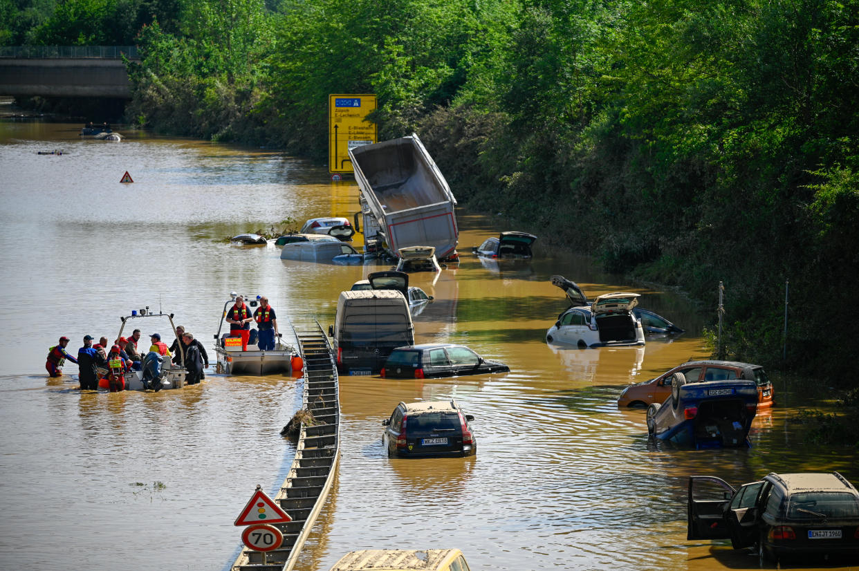 ERFTSTADT, GERMANY - JULY 17: Search and rescue teams are seen on a flooded and damaged part of the highway (A1) on July 17, 2021 in Erftstadt, Germany. The death toll in western Europe rose to 150 after record rainfall this week caused rivers to burst their banks, resulting in widespread devastation in the region. Rescue efforts continue with hundreds still unaccounted for, as the water recedes and the clean-up begins. (Photo by Sascha Schuermann/Getty Images)
