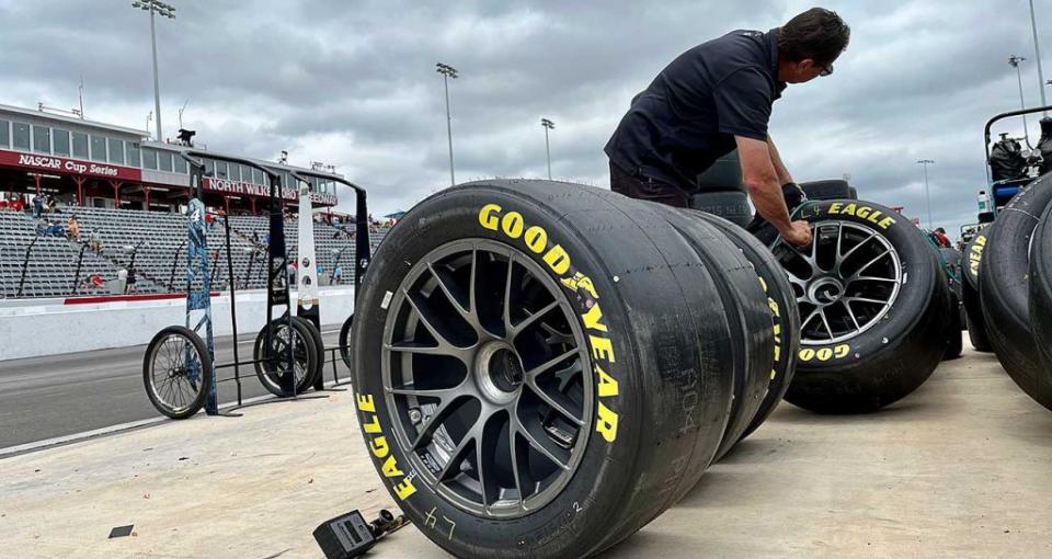 A tire technician checks out Cup Series tires for Stewart-Haas Racing on the pit road at North Wilkesboro Speedway