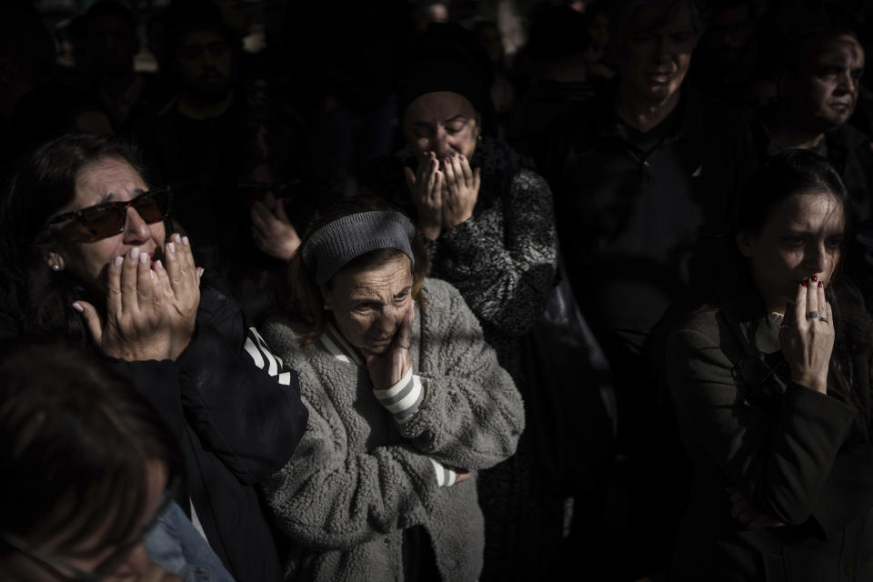 Family and friends of Israeli soldier Lt. Yaacov Elian mourn over his grave during his funeral at Kiryat Shaul cemetery in Tel Aviv, Israel, Friday, Dec. 22, 2023. Elian, 20, was killed during Israel's ground operation in the Gaza Strip, where it has been battling Palestinian militants in the war ignited by Hamas' Oct. 7 attack into Israel. (AP Photo/Oded Balilty)