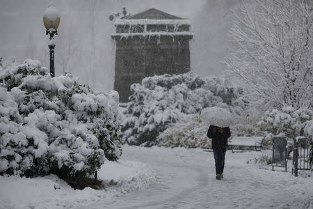 A pedestrian walks through the snow outside the U.S. Capitol in Washington, U.S., March 21, 2018. REUTERS/Aaron P. Bernstein