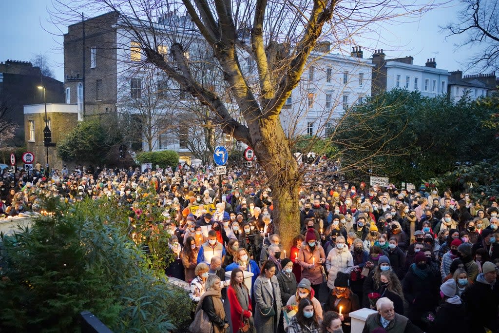 People hold a vigil outside the London Irish Centre in Camden (Dominic Lipinski/PA) (PA Wire)