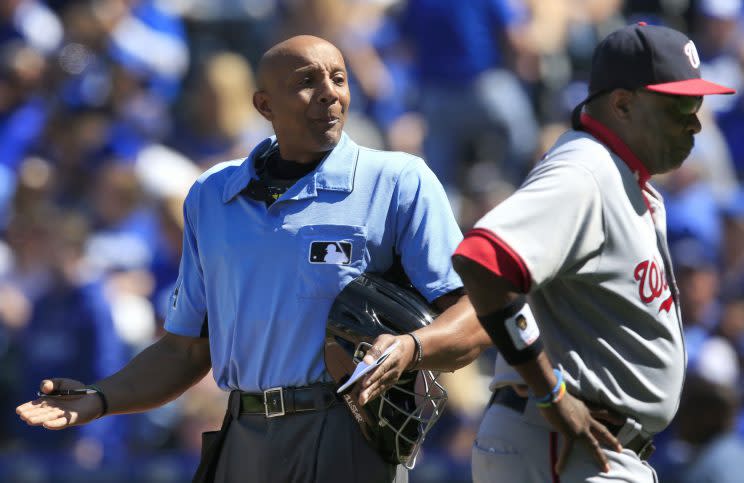 Home plate umpire CB Bucknor, left, talks with Washington Nationals manager Dusty Baker, right, during the seventh inning of a baseball game against the Kansas City Royals at Kauffman Stadium in Kansas City, Mo., Wednesday, May 4, 2016. The Nationals defeated the Royals 13-2. (AP Photo/Orlin Wagner)