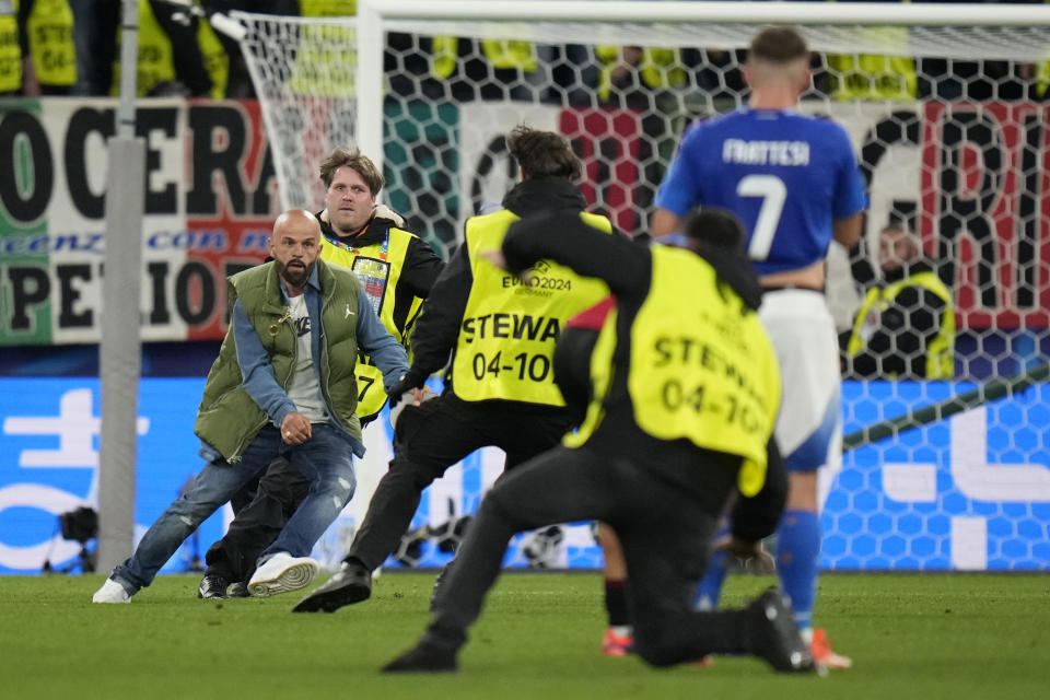 A pitch invader runs on the field during a Group B match between Italy and Albania at the Euro 2024 soccer tournament in Dortmund, Germany, Saturday, June 15, 2024. (AP Photo/Alessandra Tarantino)