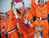 Russian skating fans, colors of their national flag painted on faces, cheer for a country skater during the men's 1,000-meter speedskating race at the Adler Arena Skating Center at the 2014 Winter Olympics, Wednesday, Feb. 12, 2014, in Sochi, Russia. (AP Photo/Pavel Golovkin)