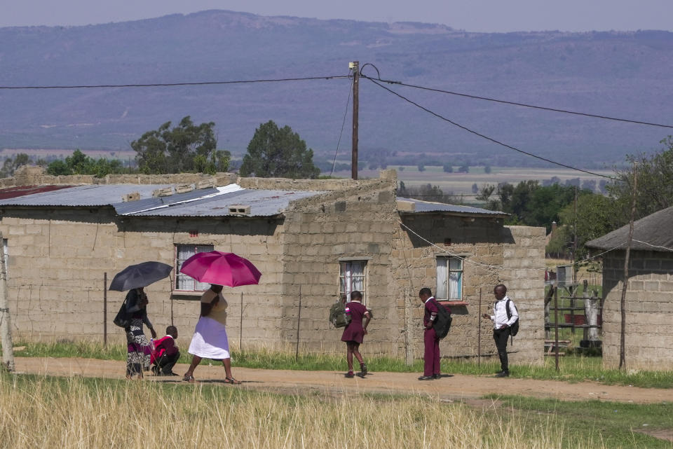 A group of school children from Ubusi Combined School play along the way as they prepare to embark on their walk back to their various homes at the end of the day near Dundee, South Africa, Thursday, Oct. 26, 2023. Thousands of children in South Africa's poorest and most remote rural communities still face a miles-long walk to school, nearly 30 years after the country ushered in democratic change. (AP Photo/ Sebabatso Mosamo)