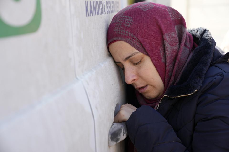 A mother mourns the loss of her daughter, as her body is transferred to Syria, from the Turkish crossing point of Cilvegozu, in Reyhanli, southeastern Turkey, Thursday, Feb. 9, 2023. Rescuers pulled more survivors from beneath the rubble of collapsed buildings Thursday, but hopes were starting to fade of finding many more people alive more than three days after a catastrophic earthquake and series of aftershocks hit Turkey and Syria. (AP Photo/Hussein Malla)