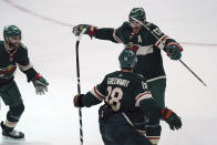 Minnesota Wild's Marcus Foligno (17) leaps as he celebrates his overtime goal off Chicago Blackhawks goalie Kevin Lankinen in an NHL hockey game, Saturday, Jan. 22, 2022, in St. Paul, Minn. The Wild won 4-3. (AP Photo/Jim Mone)