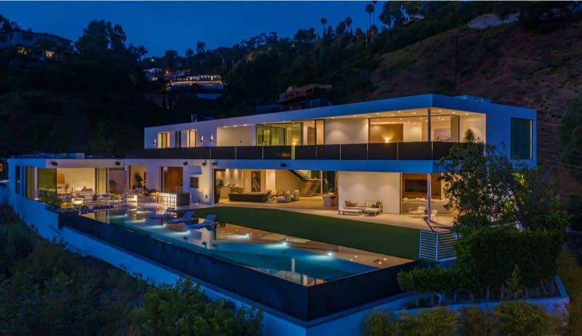 The 10,700-square-foot mansion in Benedict Canyon opens to a 100-foot saltwater pool with sweeping views of the city below.