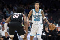 Portland Trail Blazers guard Scoot Henderson (00) guards Charlotte Hornets guard Tre Mann (23) during the first half of an NBA basketball game Wednesday, April 3, 2024, in Charlotte, N.C. (AP Photo/Jacob Kupferman)