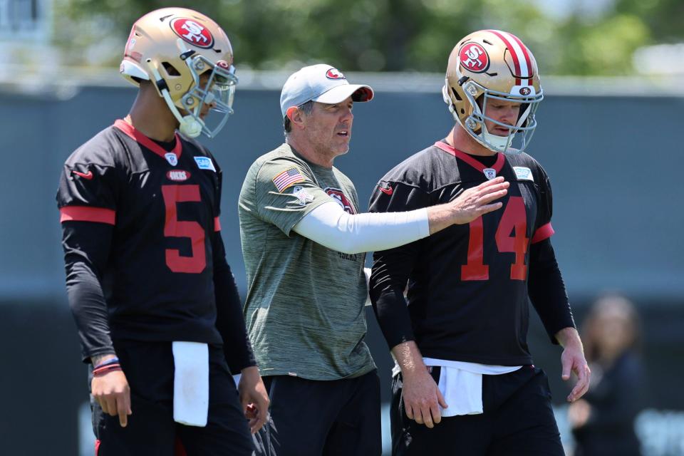 San Francisco 49ers quarterback coach Brian Griese talks with quarterback Sam Darnold (14) during the NFL football team's organized team activities in Santa Clara, Calif., Wednesday, May 31, 2023.