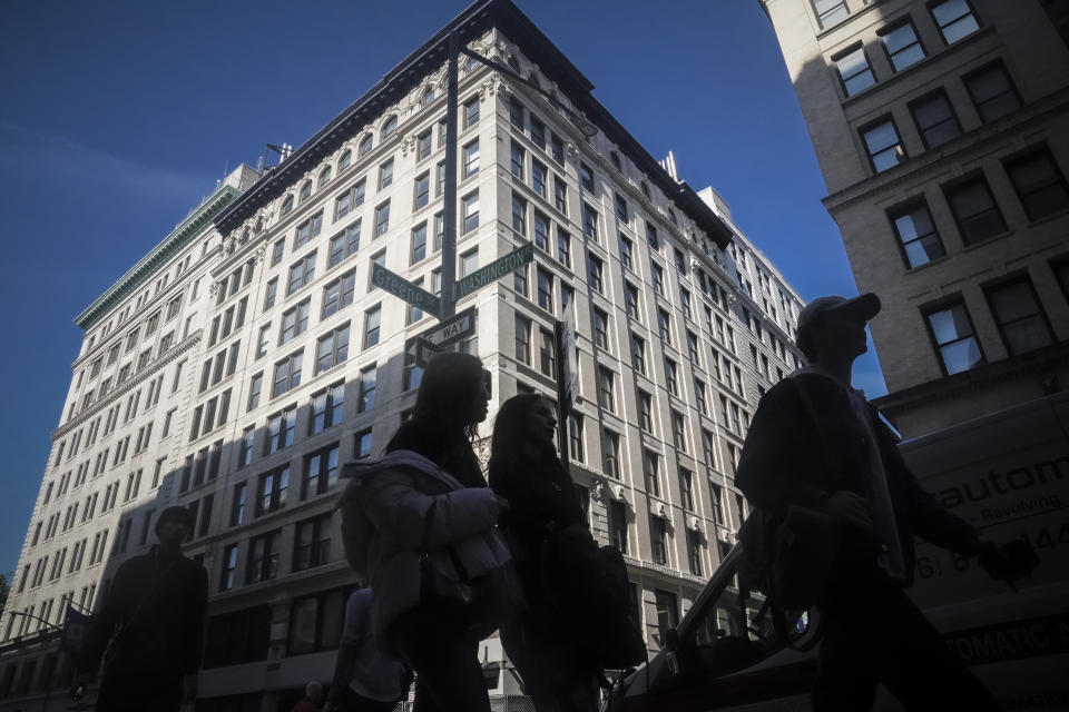 Pedestrians walk by New York University's biology building, the site of the Triangle Shirtwaist Memorial, Tuesday Oct. 10, 2023, in New York. The building is the site where 146 people, mostly immigrant girls and women, were killed in a 1911 clothing factory fire. (AP Photo/Bebeto Matthews)