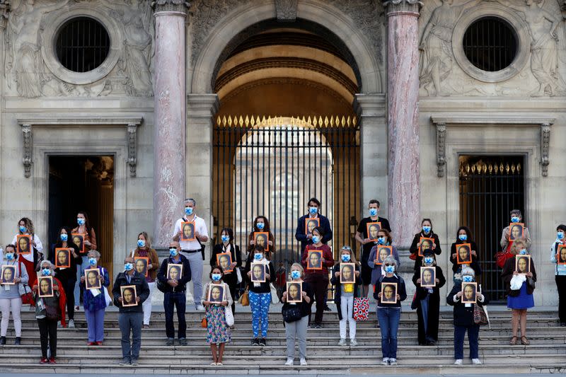 Paris tour guides gather at Le Louvre museum in Paris