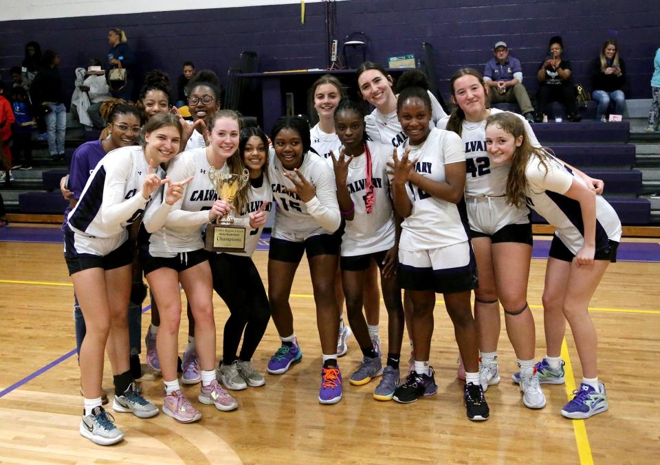 The Calvary girls celebrate after winning the Region 3-3A championship.