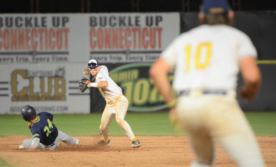 Norwich Sea Unicorns shortstop Zach Donohue looks to run a double play as Vermont's Jack Winnay slides into second base.