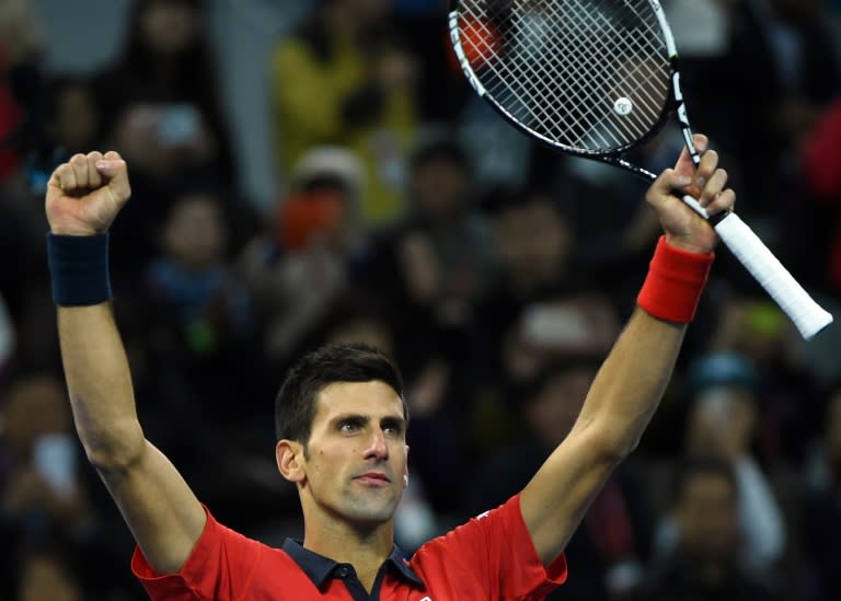 Novak Djokovic celebrates his victory over David Ferrer in their semi-final match at the China Open in Beijing, on October 10, 2015