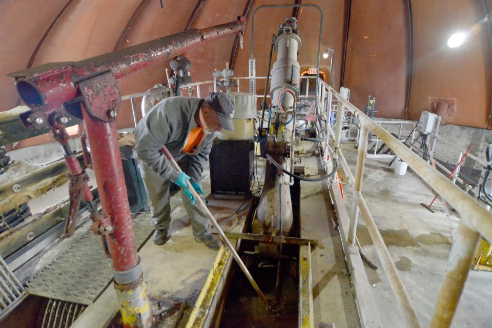 Inside the sequencing batch reactor on Wednesday at the Provincetown wastewater treatment facility, Plant Manager Chris Rowe scoops up  "flushable" wipes from one of the influent channels to show how the items can clog and damage the system. Two state legislators say the "flushable" product labeling is misleading, and that the public needs more education about how the wipes can damage sewer facilities.