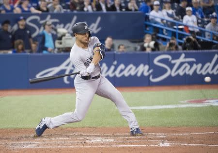 Mar 29, 2018; Toronto, Ontario, CAN; New York Yankees right fielder Giancarlo Stanton (27) hits a home run in the ninth inning during the Toronto Blue Jays home opener at Rogers Centre. Mandatory Credit: Nick Turchiaro-USA TODAY Sports