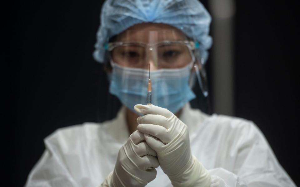 A health worker prepares a syringe for administering the AstraZeneca vaccine  - Sirachai Arunrugstichai/Getty