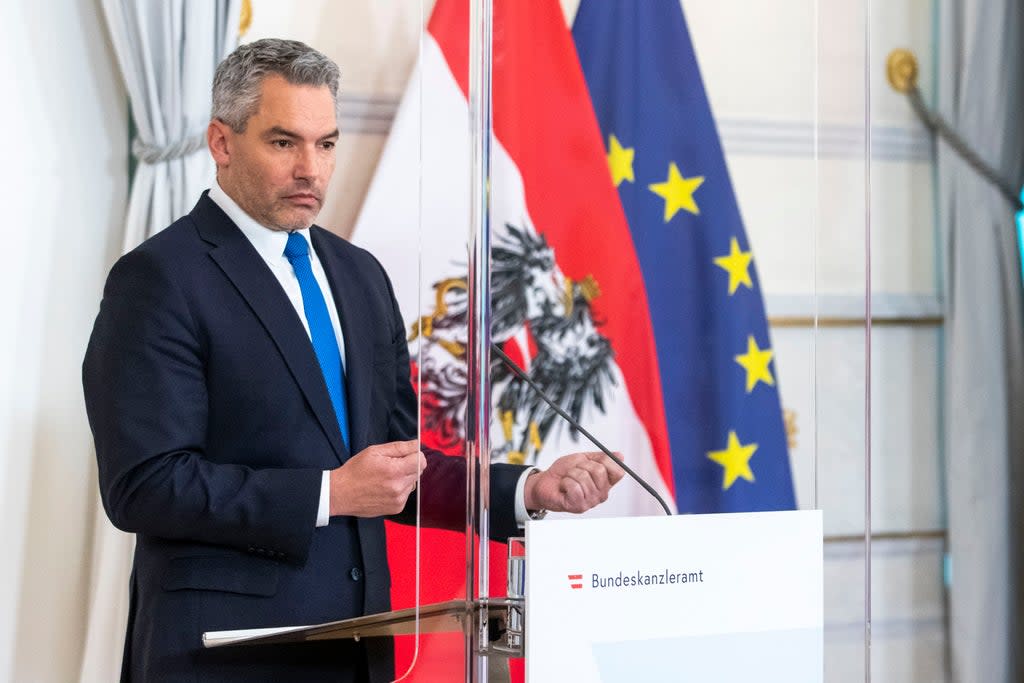 The new Austrian Chancellor Karl Nehammer speaks at a news conference in Vienna (AP)