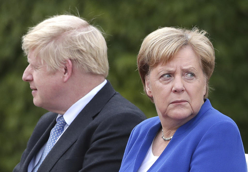 German Chancellor Angela Merkel welcomes Britain's Prime Minister Boris Johnson for a meeting at the Chancellery in Berlin, Germany, Wednesday, Aug. 21, 2019. (AP Photo/Michael Sohn)