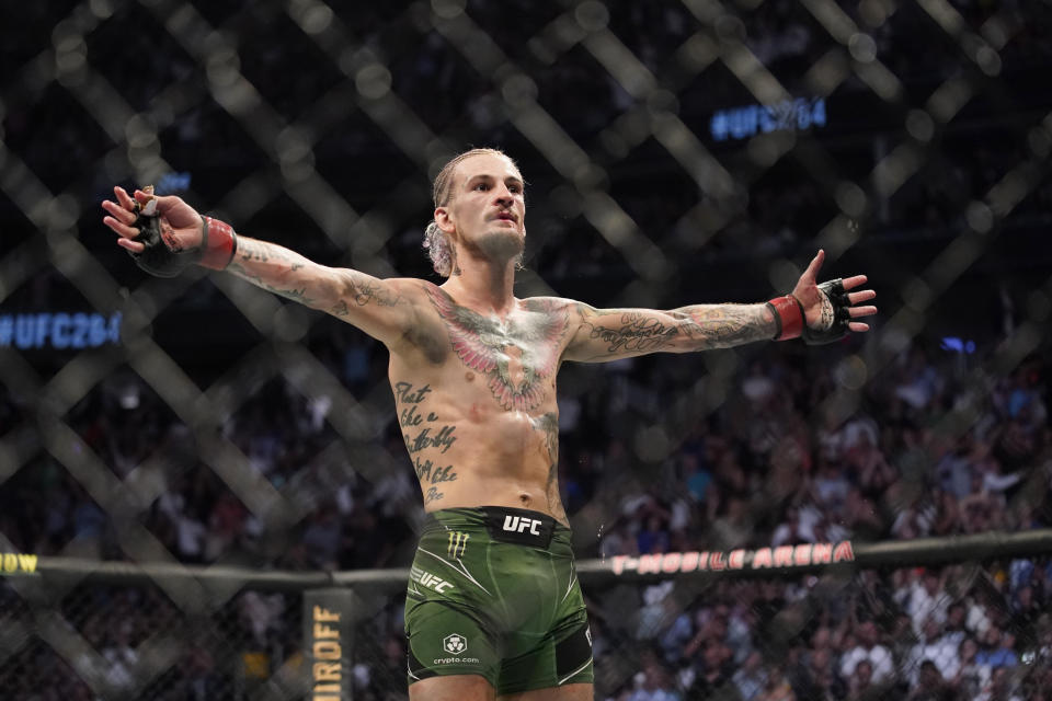 Sean O'Malley celebrates during his super bantamweight mixed martial arts bout against Kris Moutinho at UFC 264 on Saturday, July 10, 2021, in Las Vegas.  (AP Photo/John Locher)