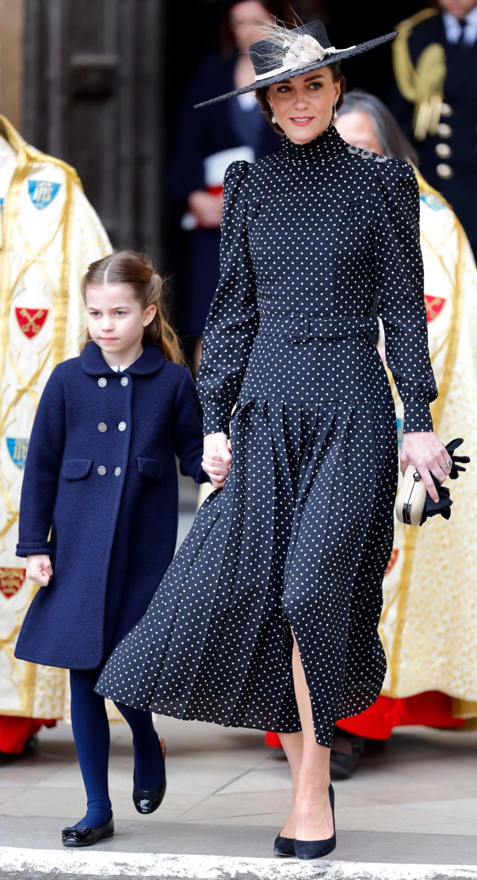 <p>The Princess of Wales opted for a belted black dress with white polka dots and puff sleeves at <a href="https://people.com/tag/prince-philip/" rel="nofollow noopener" target="_blank" data-ylk="slk:Prince Philip" class="link ">Prince Philip</a>'s <a href="https://people.com/royals/prince-george-princess-charlotte-join-kate-middleton-prince-william-prince-philip-memorial-service/" rel="nofollow noopener" target="_blank" data-ylk="slk:memorial service" class="link ">memorial service</a> in March, completing the look with a coordinated hat and black pumps. Princess Charlotte held her mother's hand as they walked into Westminster Abbey, respectfully dressed in navy.</p>