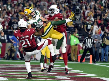 January 16, 2016; Glendale, AZ, USA; Green Bay Packers wide receiver Jeff Janis (83) catches a touchdown pass against Arizona Cardinals cornerback Patrick Peterson (21) and free safety Rashad Johnson (26) during the second half in a NFC Divisional round playoff game at University of Phoenix Stadium. Mandatory Credit: Kyle Terada-USA TODAY Sports