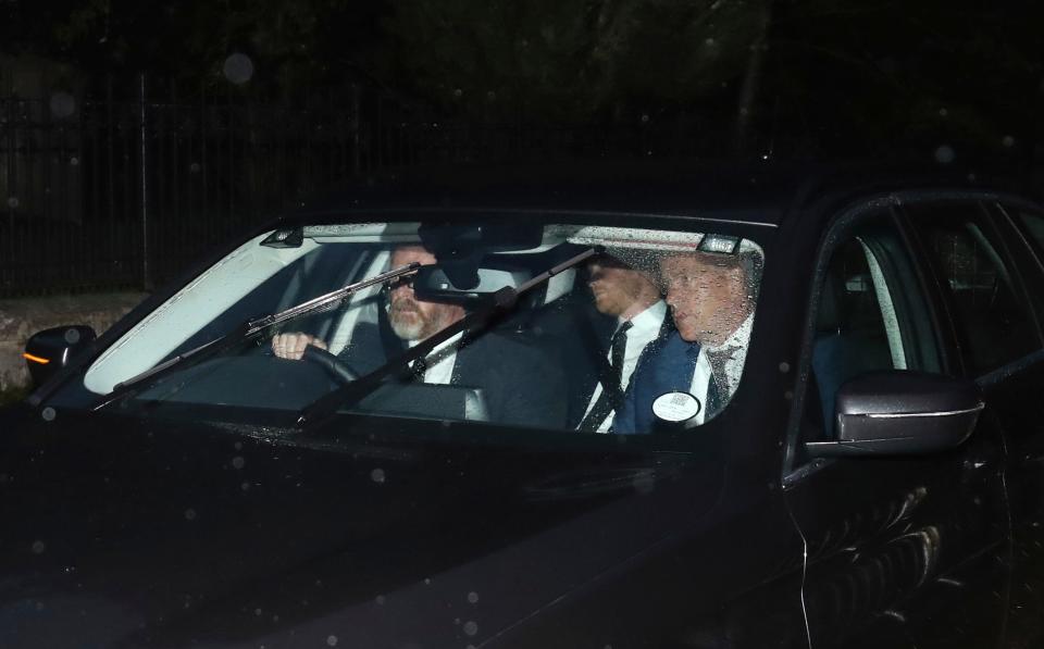 Prince Harry, center, with bodyguards, arrives at Balmoral Castle in Scotland, to be with his family on the day his grandmother, Queen Elizabeth II, died there, Sept. 8, 2022, after 70 years on the throne.