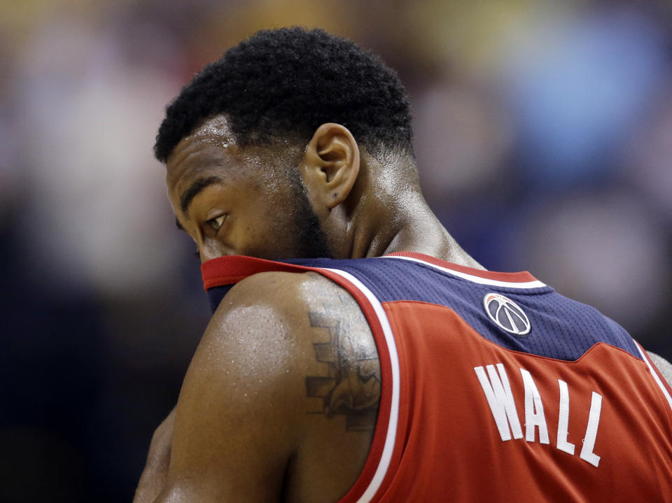 Washington Wizards' John Wall wipes his face during the second half of game 2 of the Eastern Conference semifinal NBA basketball playoff series against the Indiana Pacers, Wednesday, May 7, 2014, in Indianapolis. Indiana won 86-82. (AP Photo/Darron Cummings)