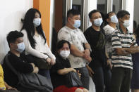 People wait for news on their relatives who are on board of Sriwijaya Air passenger jet that lost contact with air traffic controllers after take off, at Soepadio International Airport in Pontianak, West Kalimantan, Indonesia, Saturday, Jan. 9, 2021. A Sriwijaya Air passenger jet with 56 passengers and six crew members onboard, lost contact with air traffic controllers after taking off from Indonesia's capital on Saturday on a domestic flight, officials said. (AP Photo/Helmansyah)