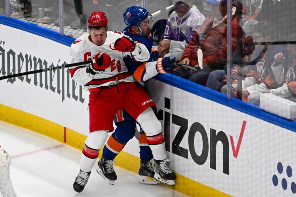 Apr 25, 2024; Elmont, New York, USA; Carolina Hurricanes defenseman Dmitry Orlov (7) checks New York Islanders right wing <a class="link " href="https://sports.yahoo.com/nhl/players/4194/" data-i13n="sec:content-canvas;subsec:anchor_text;elm:context_link" data-ylk="slk:Cal Clutterbuck;sec:content-canvas;subsec:anchor_text;elm:context_link;itc:0">Cal Clutterbuck</a> (15) during the first period in game three of the first round of the 2024 Stanley Cup Playoffs at UBS Arena. Mandatory Credit: Dennis Schneidler-USA TODAY Sports Dennis Schneidler/Dennis Schneidler-USA TODAY Sports