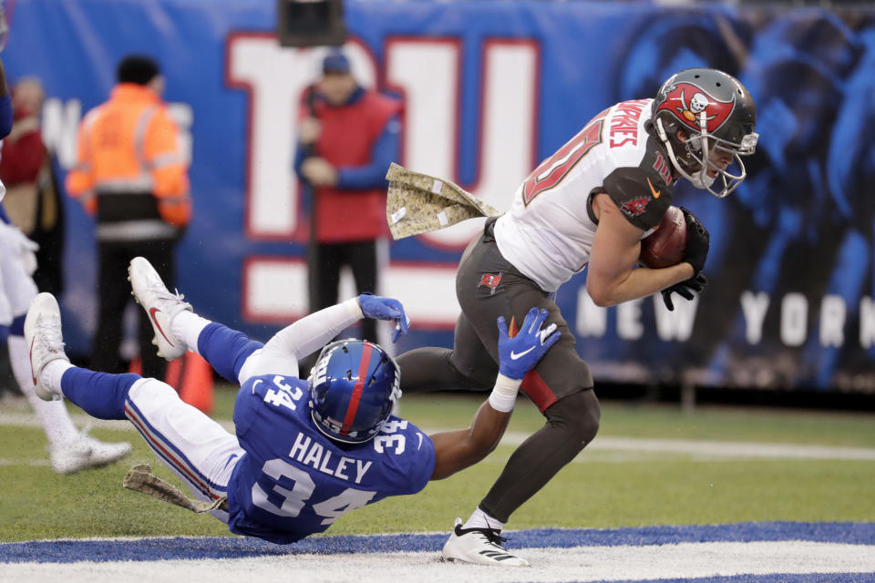 Tampa Bay Buccaneers' Adam Humphries, right, scores a touchdown past New York Giants' Grant Haley during the second half of an NFL football game, Sunday, Nov. 18, 2018, in East Rutherford, N.J. (AP Photo/Julio Cortez)