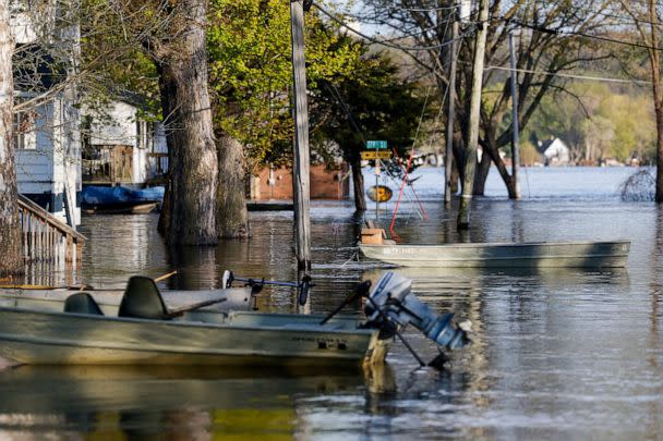 PHOTO: Boats float tethered in the front yards of homes as the Mississippi River continues to rise, forcing residents to find alternative means of transportation, April 27, 2023, in Pleasant Valley, Iowa. (Nikos Frazier/Quad City Times via AP)