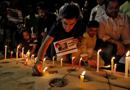 Activists of the youth wing of India's main opposition Congress party light candles during a vigil for environmental activist GD Agarwal also known as Swami Gyan Swaroop Sanand after he passed away while he was on a fast-unto-death seeking cleansing of the Ganges river, in New Delhi, India, October 11, 2018. REUTERS/Anushree Fadnavis