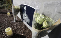 Flowers and candles rest near a sign for the Seattle Seahawks NFL football team headquarters Tuesday, Oct. 16, 2018, in Renton, Wash. in tribute to team owner Paul Allen, who died Monday, Oct. 15, 2018 in Seattle. (AP Photo/Ted S. Warren)