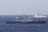 A ship (top) of the Chinese Coast Guard is seen near a ship of the Vietnam Marine Guard in the South China Sea, off shore of Vietnam in this May 14, 2014 file photo. REUTERS/Nguyen Minh/Files