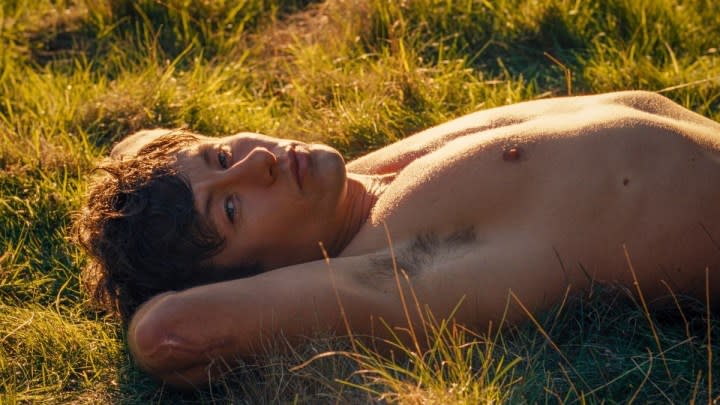 A man lays in the grass in Saltburn.