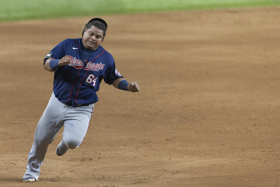 Minnesota Twins' Willians Astudillo rounds third base before scoring a run on a triple by Luis Arraez during the tenth inning of a baseball game against the Texas Rangers in Arlington, Texas, Friday, June 18, 2021. (AP Photo/Andy Jacobsohn)