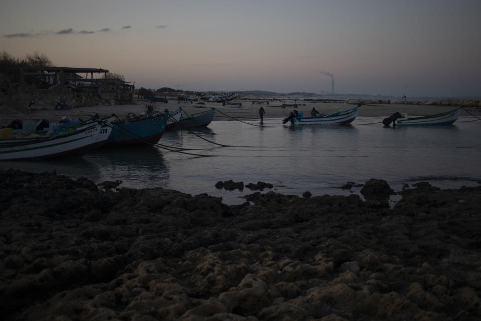 Fishermen unload their nets after returning from a fishing trip on the Mediterranean Sea, in the Israeli Arab village of Jisr al-Zarqa, Israel, in the early morning of Thursday, Feb. 25, 2021. After weathering a year of the coronavirus pandemic, an oil spill in the Mediterranean whose culprits remain at large delivered another blow for the fishermen of Jisr al-Zarqa. (AP Photo/Ariel Schalit)