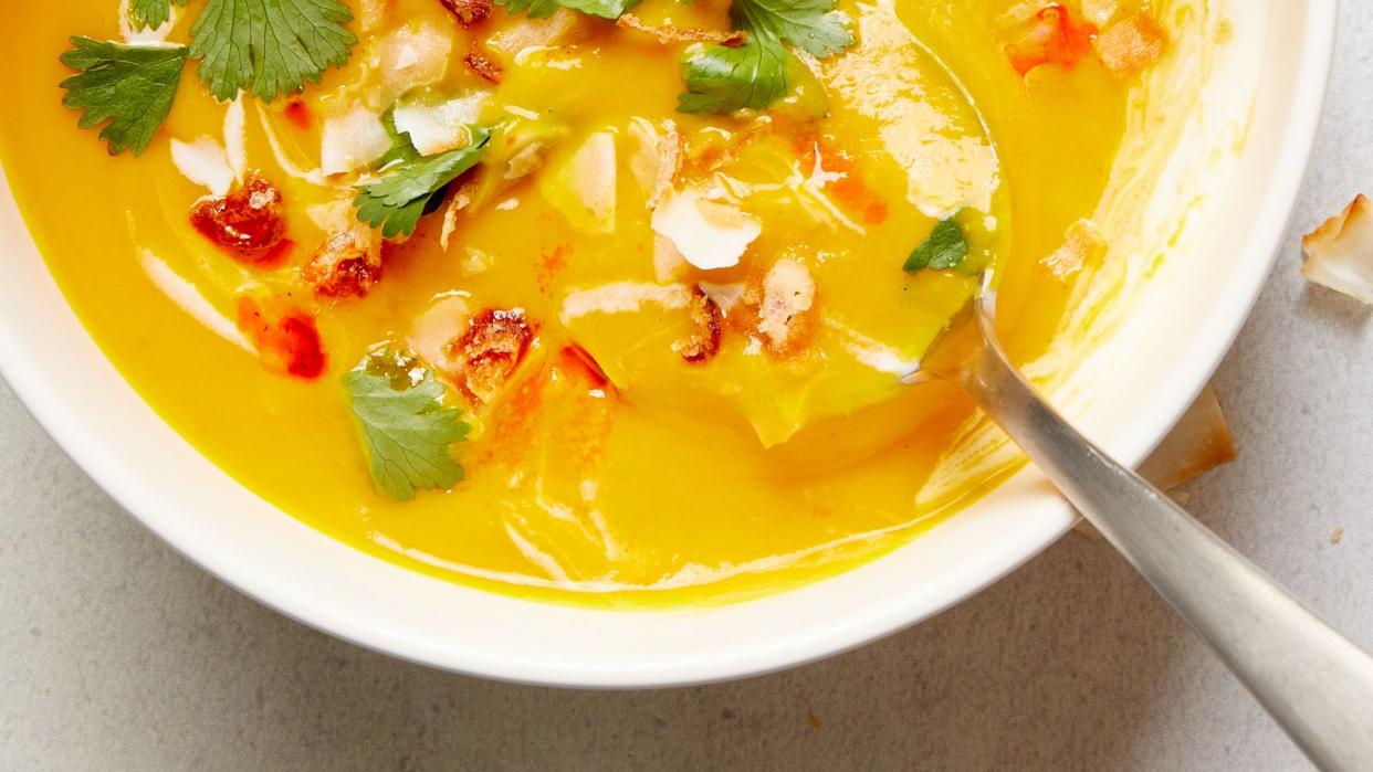 slowcooker vegan butternut squash soup garnished with coconut milk and cilantro