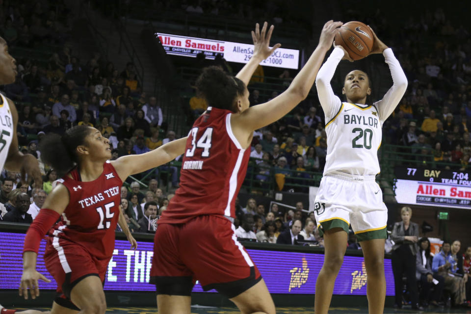 Baylor guard Juicy Landrum, right, shoots over Texas Tech guard Andrayah Adams, left, and guard Lexi Gordon, center, in the second half of an NCAA college basketball game, Saturday, Jan. 25, 2020, in Waco Texas. (AP Photo/Rod Aydelotte)