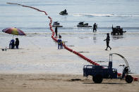 Tourists visit a beach along the Taiwan Strait in Pingtan, eastern China's Fujian Province, Sunday, Aug. 7, 2022. Taiwan said Saturday that China's military drills appear to simulate an attack on the self-ruled island, after multiple Chinese warships and aircraft crossed the median line of the Taiwan Strait following U.S. House Speaker Nancy Pelosi's visit to Taipei that infuriated Beijing. (AP Photo/Ng Han Guan)