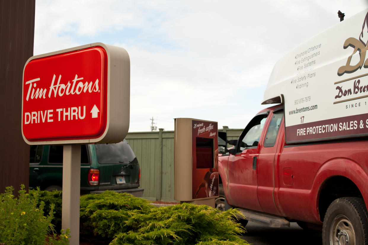 "Glace Bay, Nova Scotia Canada - August 2, 2011: A line up of vehicles waiting to be served at a local Tim Hortons coffee shop in Glaced Bay, Nova Scotia, Canada"