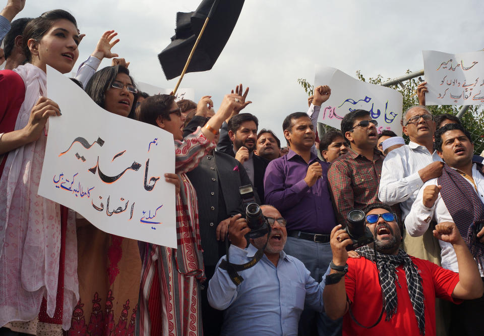 Pakistani journalists protest for their colleague Hamid Mir, who was shot and injured by gunmen in Karachi on Saturday, Monday, April 21, 2014 in Islamabad, Pakistan. Police in Pakistan said gunmen shot a famous television talk show host amid a wave of attacks on journalists in the country. Police say Hamid Mir, a host on the private television broadcaster Geo, was wounded in the attack Saturday, April 19, 2014, near Karachi's airport. Placard on left reads "we want justice for Hamid Mir." (AP Photo/B.K. Bangash)