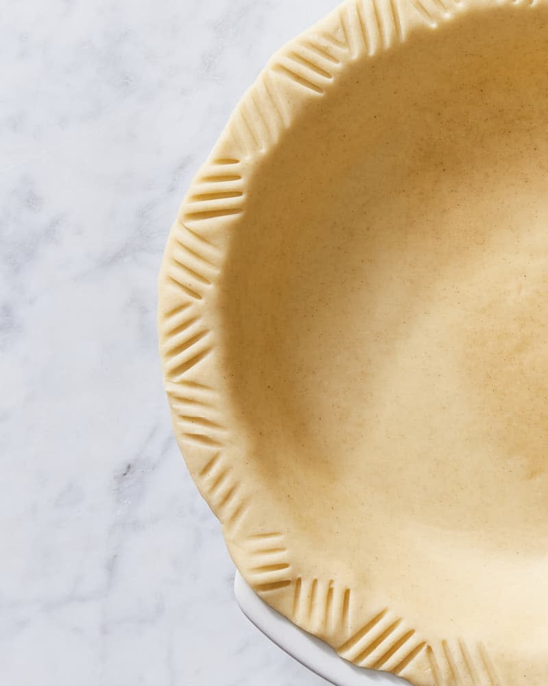 overhead macro shot of pie crust crimped with a fork