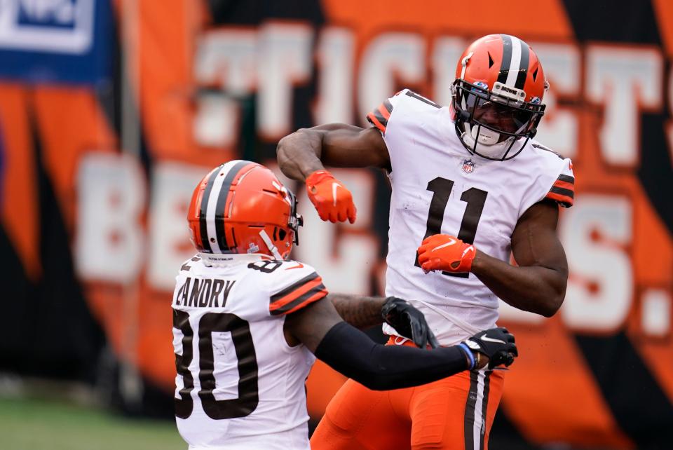 Cleveland Browns' Donovan Peoples-Jones (11) celebrates his touchdown reception with Jarvis Landry during the second half against the Cincinnati Bengals, Oct. 25, 2020, in Cincinnati.