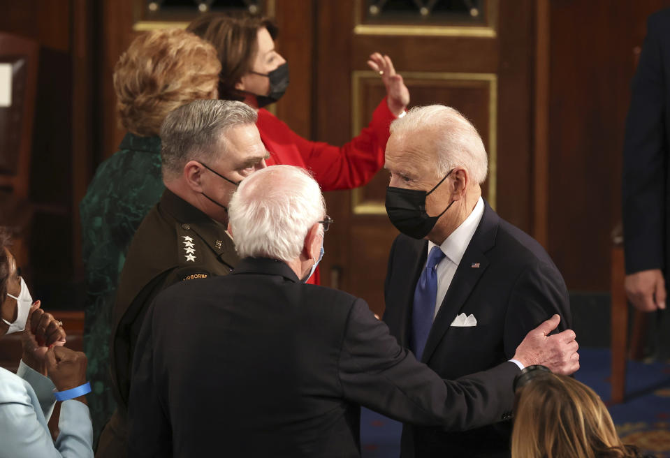 President Joe Biden speaks with Sen. Bernie Sanders, I-Vt., after addressing a joint session of congress in the House chamber of the U.S. Capitol on April 28, 2021 in Washington. (Chip Somodevilla/Pool via AP)