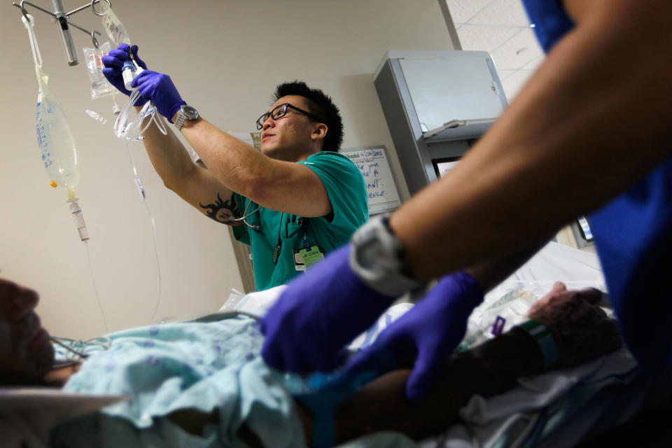 Registered Nurse Tung Tran hangs an IV bag for a patient at the University of Miami hospital's emergency department on April 30, 2012. (Photo: Joe Raedle/Getty Images)