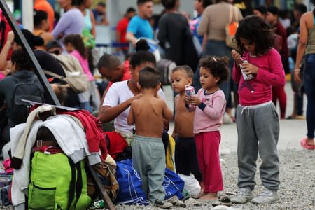 Venezuelan migrant children wait at the Binational Border Service Center of Peru in Tumbes