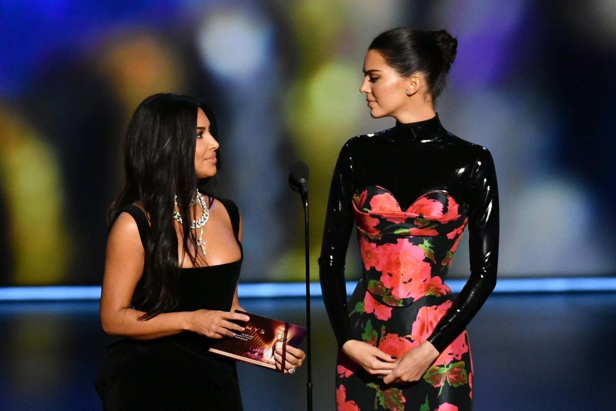 Kim Kardashian-West and Kendall Jenner on stage at the Emmys: Rex Features